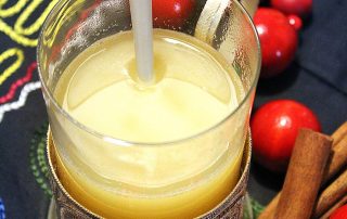 Omenasiideri lasissa, lämmin ja houkutteleva juoma.